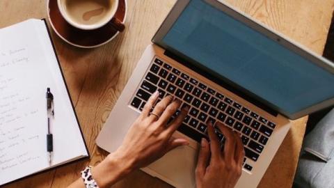 Notebook, laptop and coffee on a table