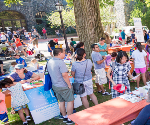 people browsing through tables outdoors