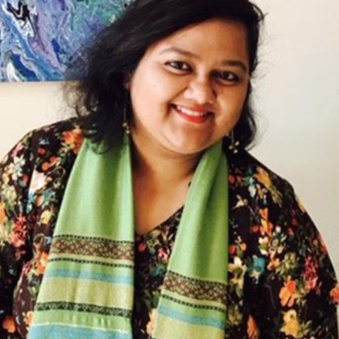 Manjari in a floral shirt and green scarf