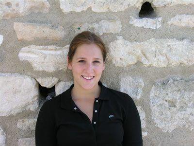 Erica Jones standing in front of a brick wall