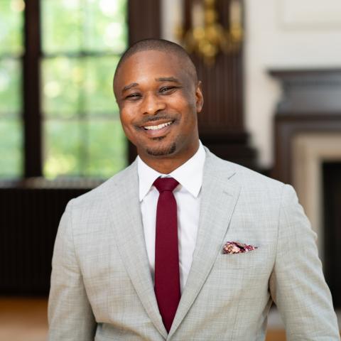 photo of Brandon terry in suit and tie beside a window