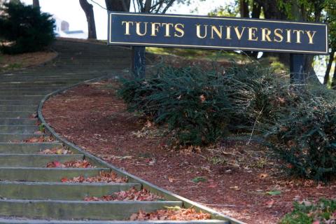 outdoor staircase with "Tufts University" sign beside it on right