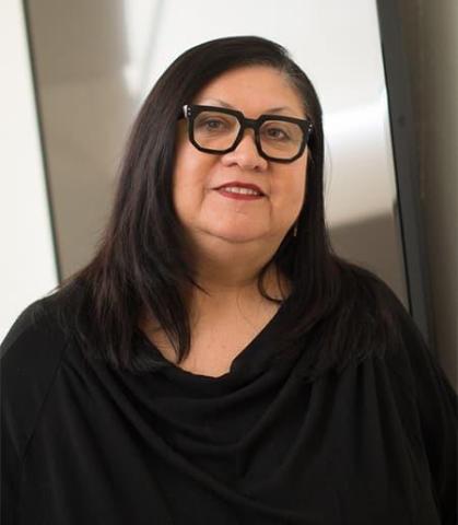 Jolene Rickard standing indoors wearing a black shirt