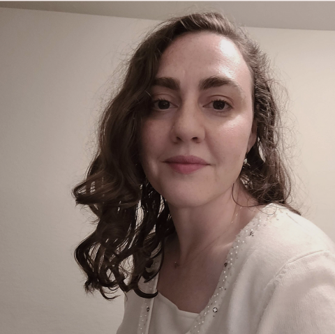 Tessa Farmer looking at the camera with a white background