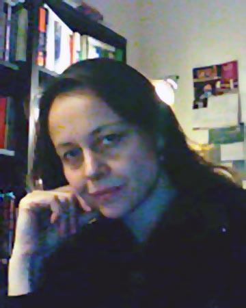 Alessandra Campana sitting in a room with a bookcase