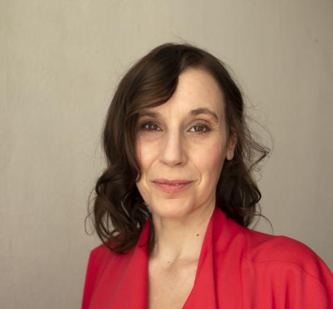 Terike Haapoja in a red shirt with beige background