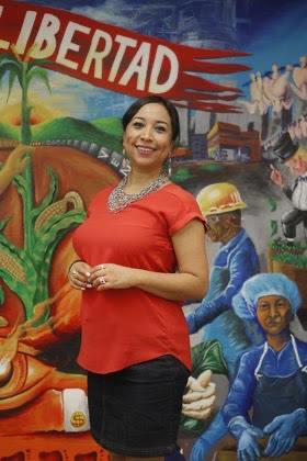 Magaly Licoli standing in front of a colorful mural
