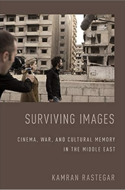 Book cover featuring black and white photo of two people walking through a city while being photographed
