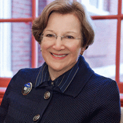 profile picture of Kim Shelemay in a blue jacket in front of a window