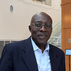 Kwasi Ampene standing in Granoff lobby