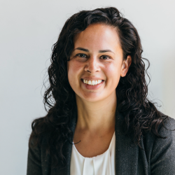 Jessica Remedios in a black blazer and a white background