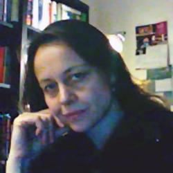 Alessandra Campana sitting in a room with a bookcase