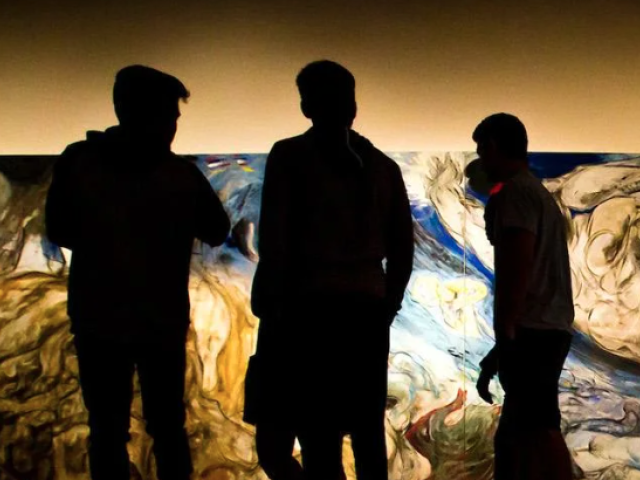 three men in silhouette, in front of an abstract art picture