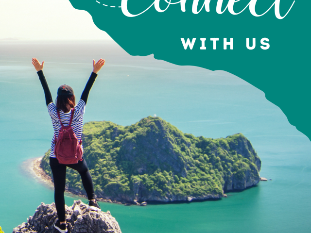 Woman celebrating on a mountaintop, looking at ocean with island in distance