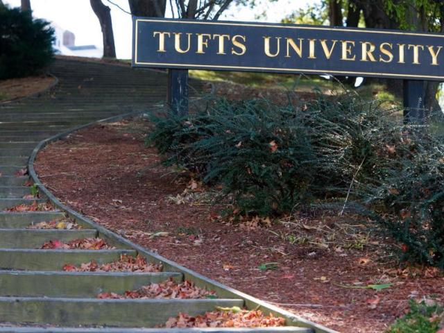 outdoor staircase with "Tufts University" sign beside it on right