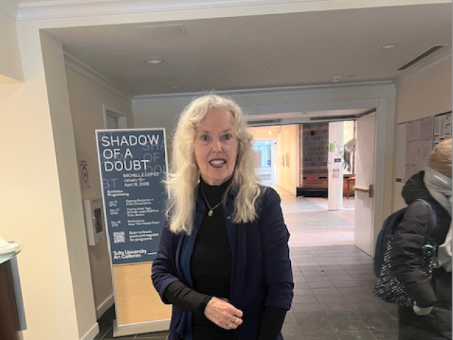 Elaine Scarry standing outside of alumnae lounge in a black dress