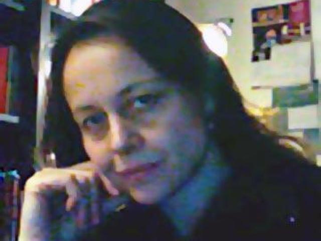 Alessandra Campana sitting in a room with a bookcase
