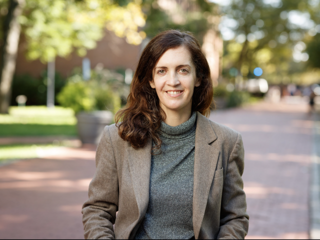 Mary Mattingly standing outdoors on a stone path